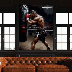 an image of a man boxing in the corner of a room with leather couches