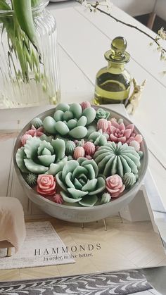 a bowl filled with flowers sitting on top of a table