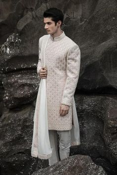 Baby pink and cream raw silk embroidered sherwani in geometric thread work. Paired with embroidered hem dupatta and churidar pant.
Component: 3
Pattern: Hand embroidered
Type Of Work: Thread work
Neckline: Mandarin collar
Sleeve Type: Full sleeves
Fabric: Raw silk
Color: White,Pink
Other Details: 
Side slit sherwani
Occasion: Groom - Aza Fashions Black Sherwani, Embroidered Sherwani, Nikkah Dress, Sherwani For Men, Kurta Set For Men, Embroidered Hem, Wedding Sherwani, Rohit Bal, Embroidered Neckline