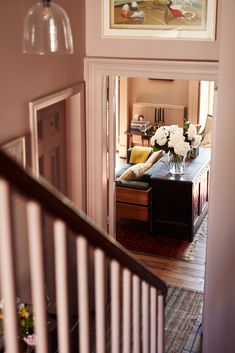 a view from the top of a staircase into a living room