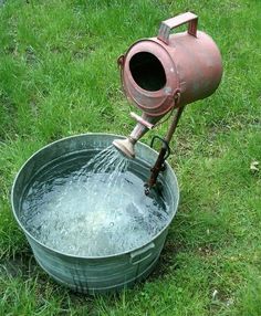 an old fashioned water pump in a bucket