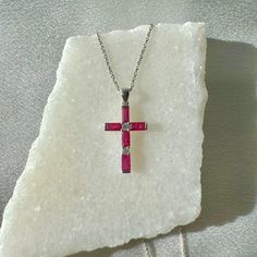 A timeless and classic design, symbolizing love, commitment and wealth. Perfect for everyday wear or dressed up for special occasions. Rubies are said to symbolize the sun, while its glowing hue suggests an inextinguishable flame within the stone. Add a pop of color with our Genuine Ruby and Diamond Baguette Cut Cross Pendant, available in 14k solid white gold and 14k solid yellow gold. 14k solid white gold and 14k solid yellow gold chain available for additional purchase to match your beautiful Diamond Baguette, Color Necklace, Ruby Pendant, Cross Jewelry, Yellow Gold Chain, Baguette Cut, Baguette Diamond, Natural Ruby, Diamond Clarity