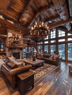 a living room filled with lots of furniture and a fire place under a chandelier