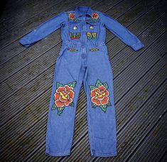 "Hand Painted Denim Boiler Suit with Traditional Old School Tattoo Roses, Dice, Butterflies, Chain and Yin Yang Flash SIZE UK 12, US 8, EU 40 Pit to Pit: 19\" Waist: 32\" Leg: 28\" All denim is upcycled, meaning each piece of painted clothing is eco friendly 🌍 This Boilersuit is in great condition! Hand Wash Only, Instructions Included. I use good quality acrylics mixed with fabric medium, which is then heat set for durability.  I'm always happy to help, so please don't hesitate to get in touch with any questions!  If you like my shop, but can't find something in your size or style, please let me know. I accept commissions and am always open to feedback.  Thanks for looking! 🌞 Please note, if buying from outside the UK, you are responsible for any customs charges. Please send me a messag Denim Boiler Suit, Tattoo Roses, Hand Painted Denim, Painted Clothing, Custom Denim, Boiler Suit, Denim Diy, Painted Denim, School Tattoo