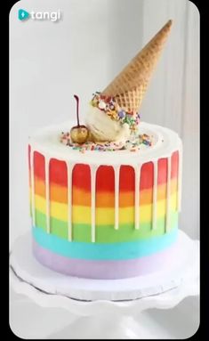 an ice cream cake with rainbow icing and sprinkles on the top