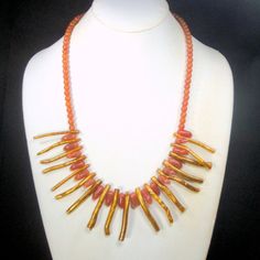 "Golden Coral SPIKE Necklace with Red Aventurine Stone Curved Points & Beads, OOAK by Rachelle Starr, Shaman, Warrior, Mermaid, Witch I am Crazy for these shiny golden textured Coral spikes The necklace is 22\" long ( 55.88cm ) plus the Golden coral spikes are about 1 1/2\" long ( 3.81cm ) average The round red aventurine beads are 1/4\" wide or 6mm The red aventurine teeth or curved spikes are each 1/4\" wide x 3/4\" long (6mm x 18mm ) tribal Drama LIGHTWEIGHT and One-of-a-kind want an exte Handmade Coral Beaded Necklaces Spiritual Style, Handmade Spiritual Coral Beaded Necklaces, Handmade Coral Beaded Necklaces For Spiritual Use, Warrior Mermaid, Shaman Warrior, Mermaid Witch, Red Aventurine, Golden Texture, Spike Necklace