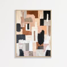 an abstract painting hangs on the wall next to a white wall with a wooden frame