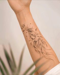 a woman's arm with a flower tattoo on the left side of her wrist