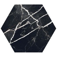 a black marble hexagonal tile with white lines on the floor and in the center