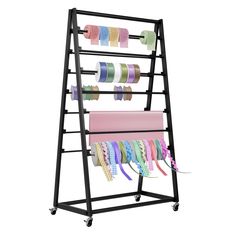 a rack with many different colored ribbons on it and two rolls of tape hanging from the top