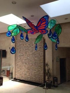 a colorful butterfly sculpture hanging from the ceiling