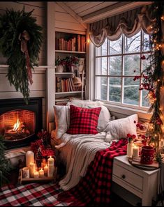 a cozy living room decorated for christmas with candles and plaid blankets on the couches