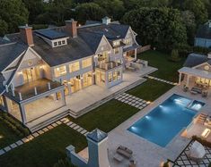 an aerial view of a large house with a pool in the yard and lots of windows