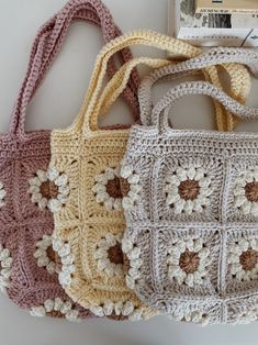 three crocheted purses sitting next to each other