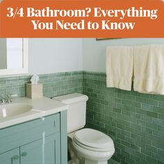 a bathroom with green tile and white fixtures