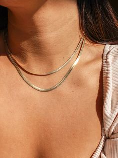 Our Athena Herringbone Necklace is a luxe essential. There is an option of a 3mm or 4mm thick chain and features a flat gold filled snake chain style. This piece adds a minimal and timeless touch when layering. Its tarnish resistant finish adds the perfect touch of sparkle to you look! Embodying the latest trend, this necklace is truly a must-have staple for your jewelry collection. * Single Herringbone Necklace (choose between a 3mm or 4mm chain) * Gold Filled * 3mm Length: 16" + 1" extender (t Minimalist Double Chain Herringbone Necklace For Everyday, Minimalist Double Chain Herringbone Necklace, Minimalist Herringbone Necklace For Everyday, Trendy Herringbone Necklace For Everyday, Minimalist Everyday Herringbone Necklace, Everyday Minimalist Herringbone Necklace, Dainty Snake Chain Necklace For Everyday, Everyday Gold Chain Herringbone Necklace, Everyday Jewelry Gold