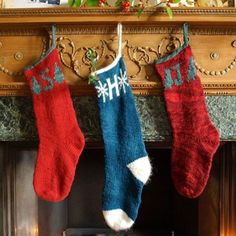 two christmas stockings hanging from a fireplace mantel