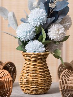 a wicker vase filled with blue and white flowers