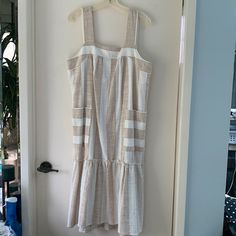 New With Tags White And Tan Stripes Loose-Fitting With Side Pockets Pit To Pit 20” Shoulder Strap To Hem Is 45.5” Cotton/Acrylic Flounced Skirt, Square Neckline Would Be Perfect For A Beach Wedding, Outdoor Picnic, Or Outdoor Bridal Shower. Size Tag Says Petite Large But Regular Large Would Fit Just Fine Too! Summer Vacation Midi Dress In Neutral Color, Summer Midi Dress For Vacation In Neutral Color, Neutral Summer Midi Dress For Vacation, Cream A-line Midi Dress For Beach, Neutral Cotton Beach Dress, Sleeveless Neutral Maxi Dress For Beach, Cream Sundress For Vacation, White Linen Sundress For Brunch, Neutral Sleeveless Maxi Dress For Beach