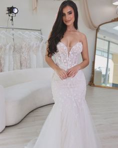 a woman in a wedding dress posing for the camera