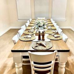 a long table with plates and place settings on it