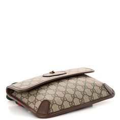 This is the authentic GUCCI GG Supreme Monogram Neo Vintage Web Belt Bag in Brown. This belt bag is crafted of the classic GG Supreme monogram coated canvas with brown leather trim. The bag features the signature green and red web adjustable canvas strap and a gold feline embellishment on the front. The front flap opens to a beige fabric interior. Web Belt, Red Web, Beige Fabric, Green And Red, Belt Bag, Leather Trims, Feline, Brown Leather, Monogram