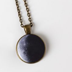 "Ever wonder what the moon looked like on your birthday? Or the birth dates of your children? The day you got married? Or the date of a person you love who passed on? This is a larger and more traditional version of our beloved birth moon necklace. Available in antique bronze or shiny silver tone, this 1 inch pendant hangs on an 18\" chain and makes a great gift. To order, please provide the following information in the \"message to seller\" at checkout: Date (in this format: MM/DD/YYYY), Time Z Moon Print Moon-shaped Necklace Gift, Moon Print Moon Shaped Necklace Gift, Moon Print Moon Shaped Necklace For Gift, Moon Shaped Necklace With Moon Print For Gift, Moon Print Necklace Perfect For Gifts, Sun And Moon Design Necklace For Anniversary, Black Round Jewelry For Birthday Gift, Sun And Moon Design Round Pendant Necklace For Gift, Circle Moon Charm Necklace For Gift