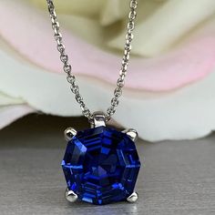 "This necklace is a web cut lab created blue sapphire, 18\"cable chain, 14k white gold #6390 September Birthstone -Approximate total carat weight: 3.30ctw diamond equivalent -Center Stone Size: 9x9mm approx. 3.30ct diamond equivalent -Center Stone Shape: web cut / octagon -Gem Type: lab created blue sapphire -Stone Clarity: VS2 -Stone Color: blue -Moh's Scale: 9 hardness -Metal Type and Purity: 14k white gold -Setting: 4 prong basket -Chain: 18\" delicate 14k gold chain / heavier option with lob Blue Sapphire Necklace With Prong Setting, Brilliant Cut Lab-created Sapphire Necklaces, Diamond Cut Lab-created Sapphire Necklace As Gift, Gift Necklace With Lab-created Sapphire And Diamond Cut, Blue Tanzanite Necklace With Brilliant Cut, Blue Round Pendant Necklace With Prong Setting, Blue Diamond Cut Round Cut Necklaces, Lab-created Sapphire Pendant Necklace, Blue Diamond-cut Lab-created Sapphire Jewelry