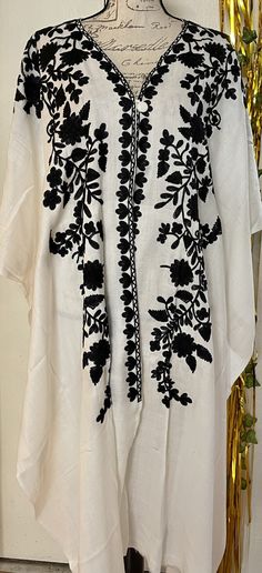 It is a beautiful long cape shawl style poncho for women. Beautiful Kashmiri Ari embroidery on it. It is open from front and a button on front. Sides are also open. It is a long length poncho . Fabric pashmina. Color white . Black Thread embroidery on it. Back side also embroided. Front and back length are same almost 43 to 44 inches. No return or exchange please. Kashmiri Embroidery Suits Design, Kashmiri Embroidery Designs, Kashmiri Embroidery Suits, Kashmiri Design, Shawl Embroidery, Long Poncho, Kashmiri Embroidery, Cotton Jackets Women, Cape Shawl