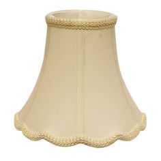 a cream colored lamp shade with scalloped edges