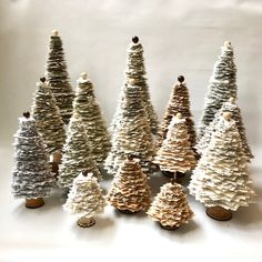 small christmas trees made out of cupcakes on a white tablecloth covered surface