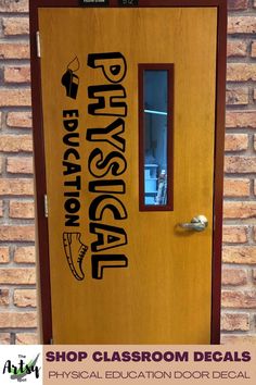 a wooden door with the words physical education decals on it, and a window