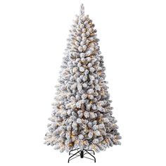 a white christmas tree covered in snow on a black stand with gold trimmings