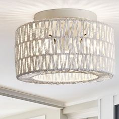 a white light fixture hanging from the ceiling