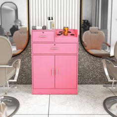 a pink cabinet sitting in front of a mirror next to hair dryers and chairs