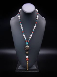 "Description and Details  Discover the beautiful Tibetan jewelry masterpiece that represents a blend of traditional and modern elements in this One-of-a-kind Deluxe long necklace!  Freshwater Pearls, Coral, and Turquoise are designed to enhance the beauty of the handmade Tibetan pendant featured in the necklace.  One-of-a-kind  Item: E 450 Freshwater Pearl  Turquoise  Tibetan Silver, Turquoise  Carved Copal Tassel: Vermeil  Clasp: Vermeil  Approx. 29\" Silk hand-knotted" Elegant 108 Beads Jewelry Gift, Elegant Necklace With 108 Beads Pendant, Luxury Gemstone Pearl Necklace, Elegant Natural Stones Jewelry For Meditation, Spiritual Single Strand Long Necklace, Elegant Natural Stone Jewelry For Meditation, Elegant Hand-strung Lariat Necklace, Elegant Hand-strung Pendant Jewelry, Elegant Necklace With 108 Beads For Gift