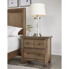 a night stand with two drawers and a lamp