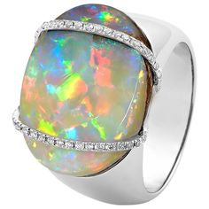 "La Gioconda" opal ring showcases an eye-catching opal (14.52ct) from our own mines in Jundah-Opalville. Inspired by the Mona Lisa’s enigmatic smile, this piece features two intricate lines of brilliant-cut diamonds embracing a light boulder opal. Set in 18K white gold, this ring is a discreet yet powerful fashion statement. Designed by Renata Bernard. The gemstone at the centre of this opal ring is an Australian boulder opal from Opal Minded's own opal mines in Jundah-Opalville in Queensland. Precious opal's distinctive quality is its "play of colour," a phenomenon which manifests in opal's colours shifting and changing as the gem moves. Australian opals, in general, are the quality benchmark for the world family of opals owing to their durability and beauty. Particulars: Size & Stone Mea Powerful Fashion, Vintage Opal Engagement Ring, The Mona Lisa, Ammolite Jewelry, Precious Opal, Diamond Cocktail Ring, Gold For Sale, Australian Boulder Opal, Diamond Cocktail Rings