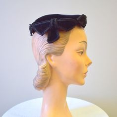 "Vintage 1950s black velvet hat with gimp trim.  Sold at Montaldos.  The hat is in good condition -- no holes or stains; it has a few spots where the nap of the velvet is dented.  The hat has a diameter of 7\". ---> If you need an order shipped by a particular date or shipped via a quicker method, please ask PRIOR to purchase to see if we can accommodate that request. Visit the rest of our shop for more goodies ---> https://www.etsy.com/shop/BlackbirdAntiquesNC Visit our shop policies page for s Adjustable Black Vintage Fascinator, Vintage Black Costume Hat With Curved Brim, Vintage Black Brimmed Mini Hat, Vintage Black Hat For Church, Retro Black Brimmed Mini Hat, Vintage Black Mini Hat For Vintage Events, Black Retro Brimmed Mini Hats, Vintage Black Mini Hat For Church, Vintage Black Fascinator