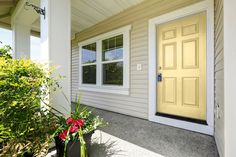 the front door of a house with two planters