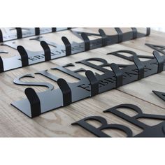 several black metal letters are arranged on a wooden surface