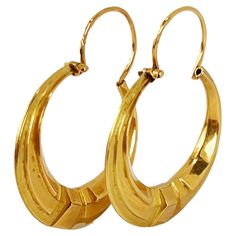 A pair of French 18 karat (18K) yellow gold hoop earrings, each designed as a Creole hoop. For pierced ears. Stamped with the eagle’s head for 18 karat gold and French manufacture with an unknown makers mark. For pierced ears. Dimensions: 2.8 x 2.1 x 0.4 cm (each) Weight: 1.73 grams (total)