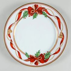 a christmas plate with holly and bells on it