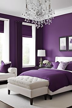 a bedroom decorated in purple and white with a chandelier hanging from the ceiling