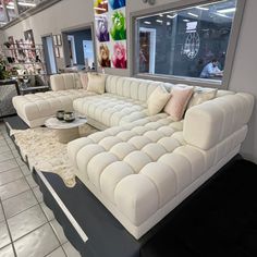 a large white couch sitting inside of a living room