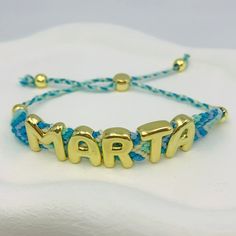 Take a dip into the ocean with our Costal Weave Custom Bracelet! This unique piece features a beautiful blue and turquoise weave, reminiscent of calming waves. Customize it with shiny gold letters for a thoughtful gift, and enjoy a comfortable fit with the adjustable closure. Wear it to add a touch of coastal beauty to your everyday look. Custom Bracelet, Custom Earrings, Gold Letters, Custom Bracelets, Custom Necklace, Custom Rings, Ring Bracelet, Ring Necklace, Beautiful Blue