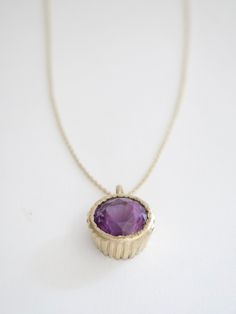 A 25 carat natural amethyst set in a hand carved and cast 14k yellow gold bezel set pendant. hangs on an 18” 14k yellow gold cable chain (included) amethyst measures 18mm in diameter. pendant is approximately 1.24” in diameter. *amethyst has a small chip on bottom shoulder which is not visible unless looking very closely Amethyst Set, Statement Pendant, Bezel Setting, Cable Chain, Hand Carved, Amethyst, Cable, It Cast, Yellow Gold