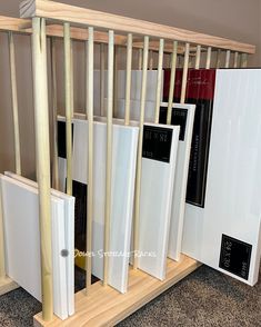 the books are lined up in front of the bookcases on the carpeted floor