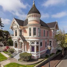 a pink victorian style house with a turret