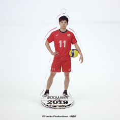 a young man holding a volleyball ball in front of a white background